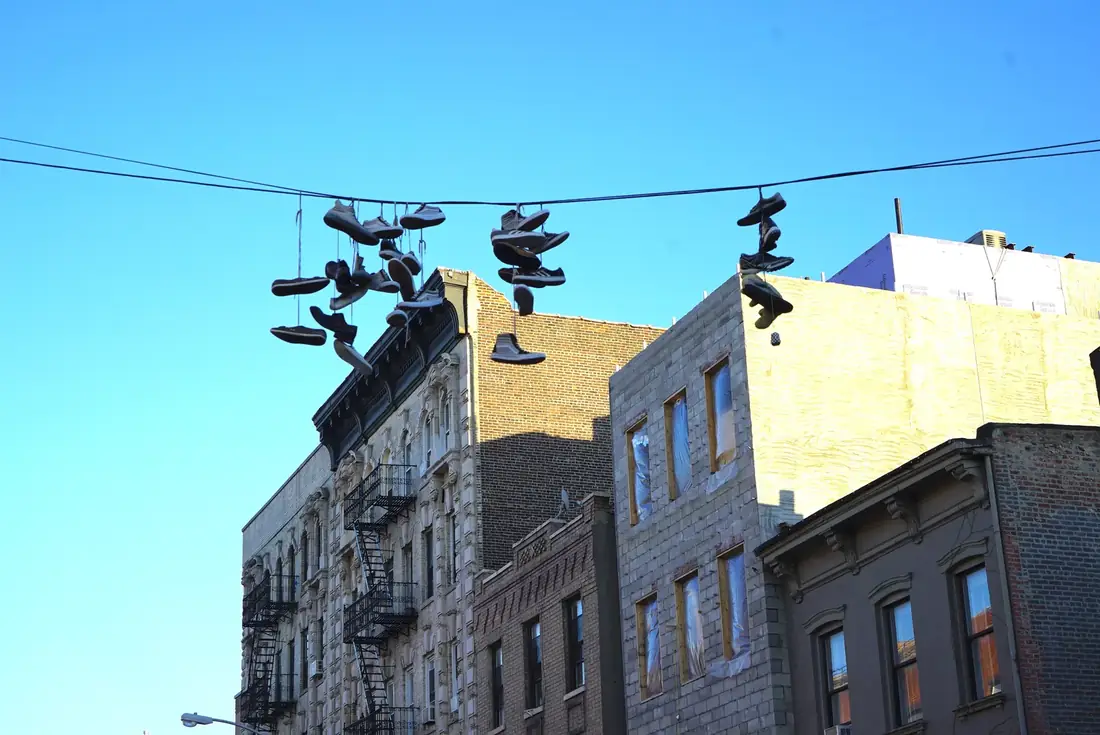 Sneakers hanging from a wire over a Brooklyn street