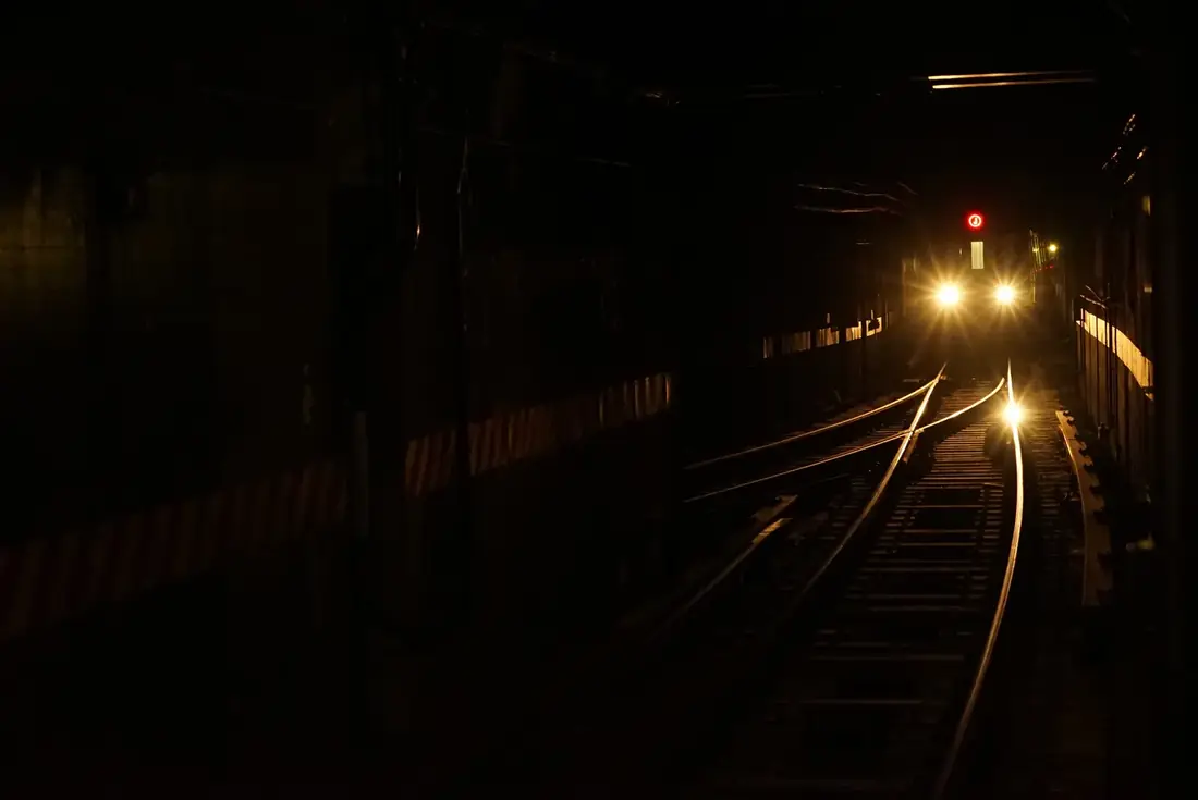 A train light in a dark subway tunnel